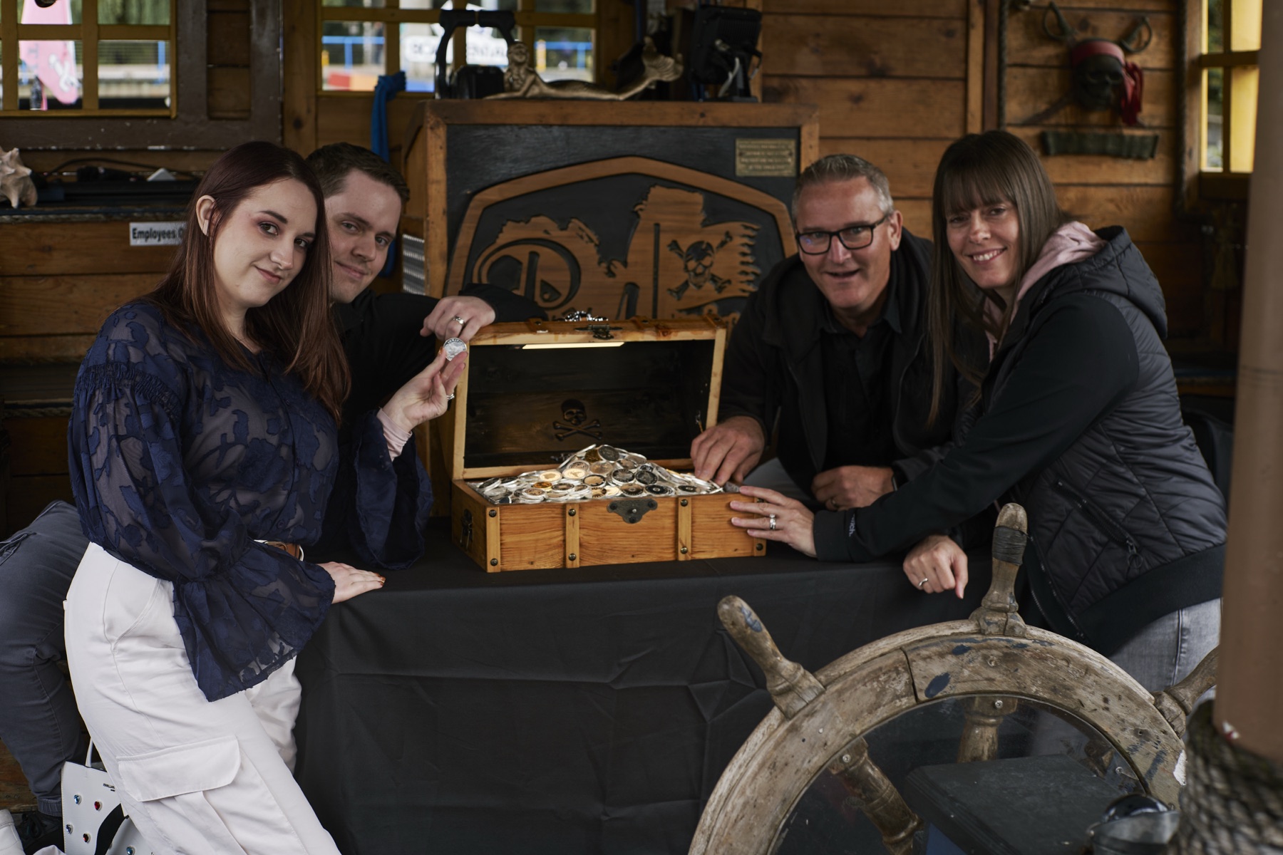 The Hunt II winning team gathered around the open treasure chest
